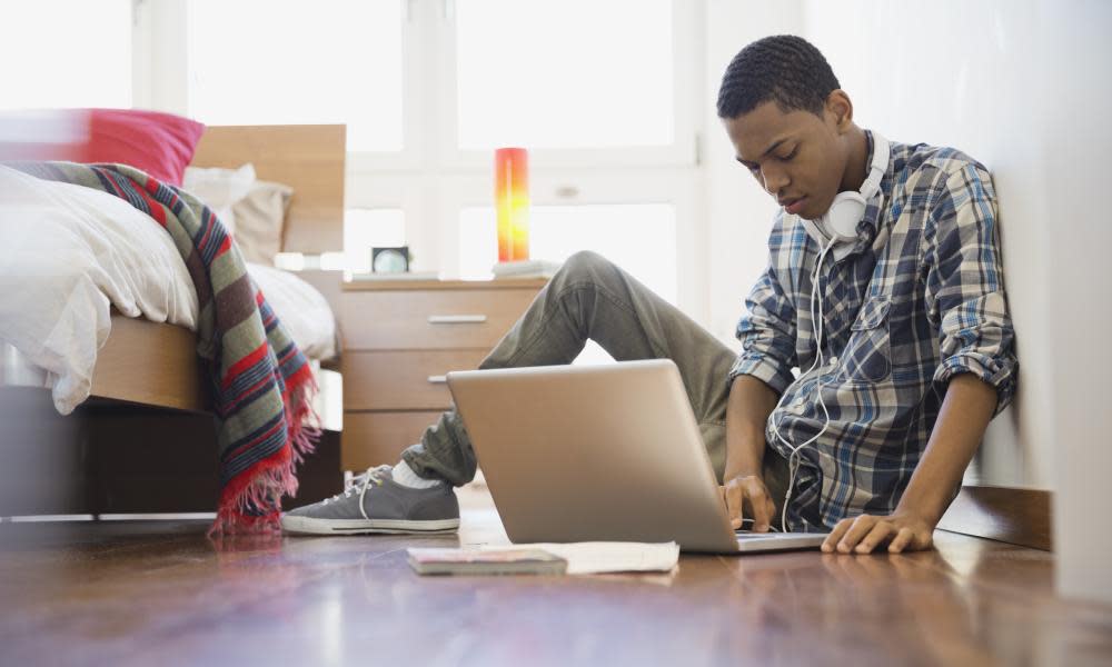 Teen using laptop at home