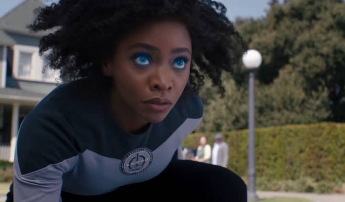 Monica Rambeau on one knee with her eyes glowing blue in "WandaVision"