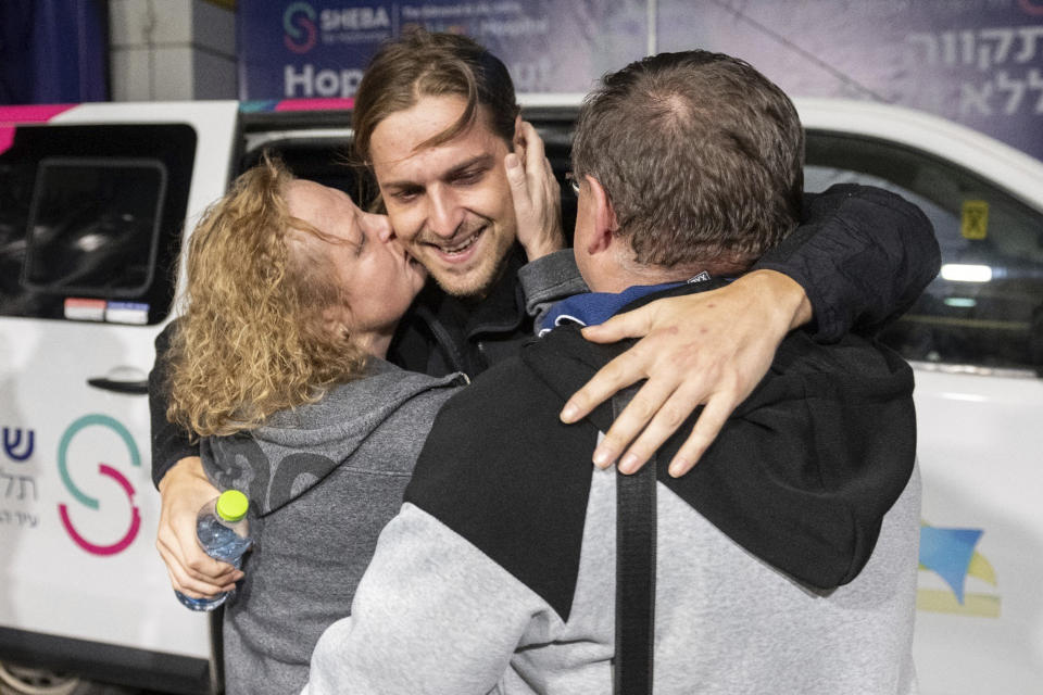 This photo released by the GPO, Ron Krivoi meets his parents at the Sheba Medical Center this past Sunday, Nov. 26, 2023, after being released from Hamas captivity. (GPO/Handout via AP)