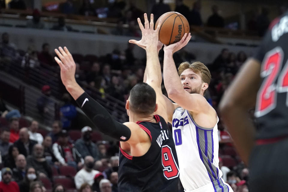 Sacramento Kings' Domantas Sabonis shoots over Chicago Bulls' Nikola Vucevic during the first half of an NBA basketball game Wednesday, Feb. 16, 2022, in Chicago. (AP Photo/Charles Rex Arbogast)