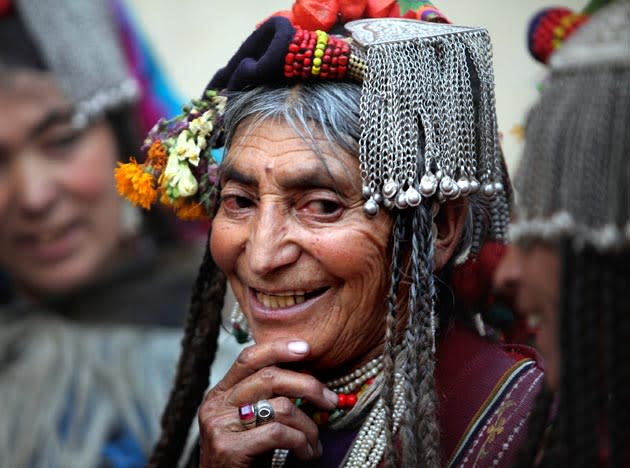 In this July 23, 2011 photo, an Aryan Brogpa woman in traditional outfit smiles at Darchik, in Kargil district of Jammu and Kashmir state, India. The Brogpas, or Dards or Drokpas as they are also known, claim to be pure-blooded Aryans and have been subjects of study and debate of historians and researchers. Brogpas, numbering over a 1000, reportedly practice polygamy and polyandry and are prohibited from marrying outside their community to preserve their racial purity. (AP Photo/Channi Anand)
