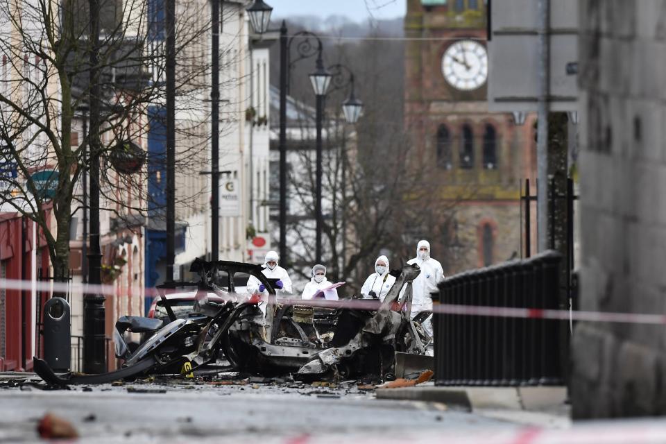 Forensic officers inspect the remains of the van used as a car bomb on an attack outside Derry Court House. (Getty Images)