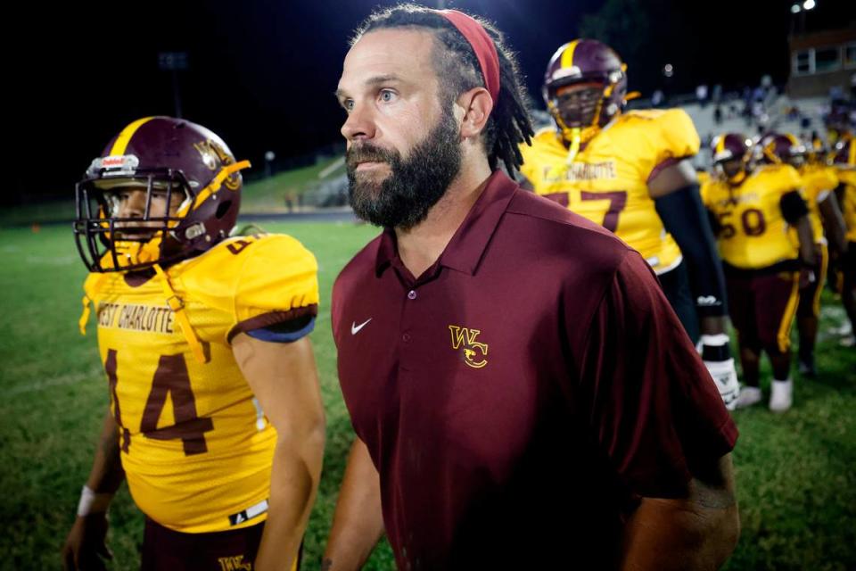 West Charlotte’s head coach Sam Greiner takes the field with the team after a game against Garinger at Waddell High School in Charlotte, N.C., Thursday, Sept. 8, 2022. West Charlotte beat Garinger 48-8. Alex Slitz/alslitz@charlotteobserver.com