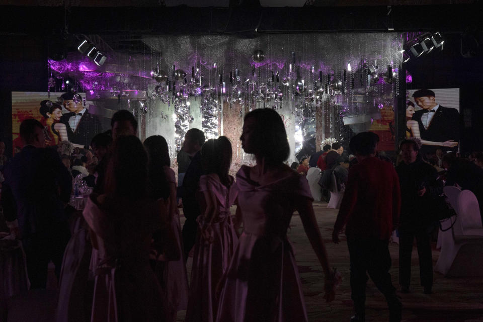 Guests attend an unmasked wedding banquet in Beijing on Saturday, Dec. 12, 2020. Lovebirds in China are embracing a sense of normalcy as the COVID pandemic appears to be under control in the country where it was first detected. (AP Photo/Ng Han Guan)