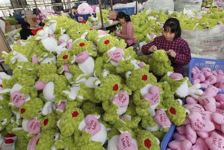 Employees make stuffed toys which they are exporting to Europe and America, at a toy factory in Lianyungang, Jiangsu province October 8, 2014. REUTERS/China Daily