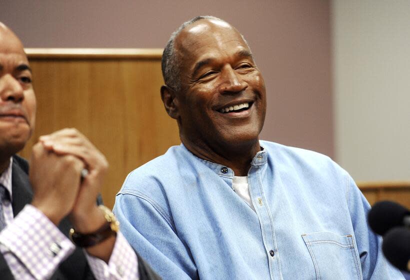 FILE - In this July 20, 2017, file photo, former NFL football star O.J. Simpson reacts after learning he was granted parole at Lovelock Correctional Center in Lovelock, Nev. Simpson got into a series of minor legal scrapes following his 1995 acquittal of murder charges in the deaths of his wife Nicole Brown Simpson and her friend Ronald Goldman. (Jason Bean/The Reno Gazette-Journal via AP, Pool, File)