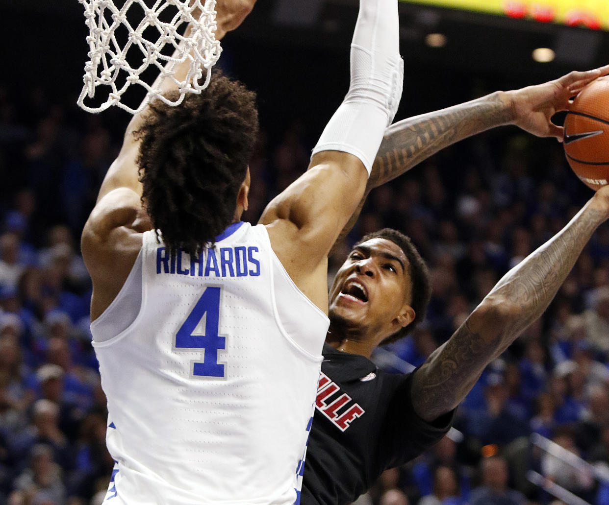 Louisville’s Ray Spalding, right, is pressured by Kentucky’s Nick Richards (4) during the first half of an NCAA college basketball game, Friday, Dec. 29, 2017, in Lexington, Ky. (AP Photo/James Crisp)