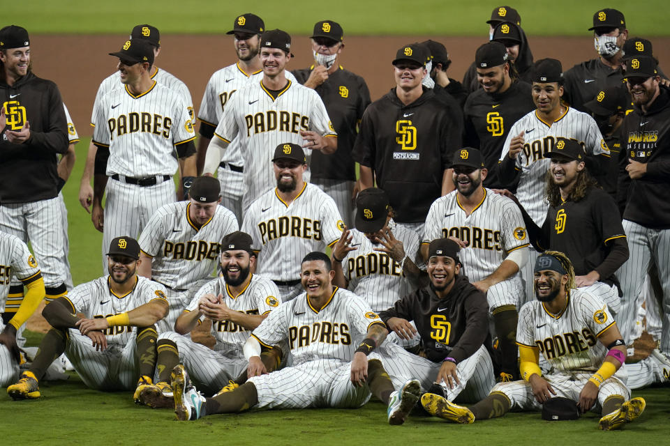 San Diego Padres pose for a photo after defeating the St. Louis Cardinals 4-0 in Game 3 of a National League wild-card baseball series Friday, Oct. 2, 2020, in San Diego. The Padres advanced to the NL Division Series. (AP Photo/Gregory Bull)