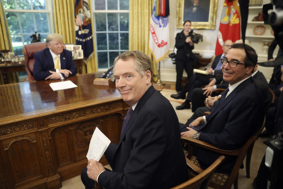 U.S. Trade Representative Robert Lighthizer and Treasury Secretary Steven Mnuchin, right, smile as they attend a meeting with President Donald Trump and Chinese Vice Premier Liu He in the Oval Office of the White House in Washington, Friday, Oct. 11, 2019. (AP Photo/Andrew Harnik)