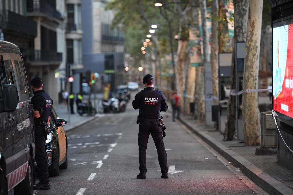 High alert: Spanish police patrol the streets of Barcelona the morning after the vehicle attack which killed 13 people: Getty Images