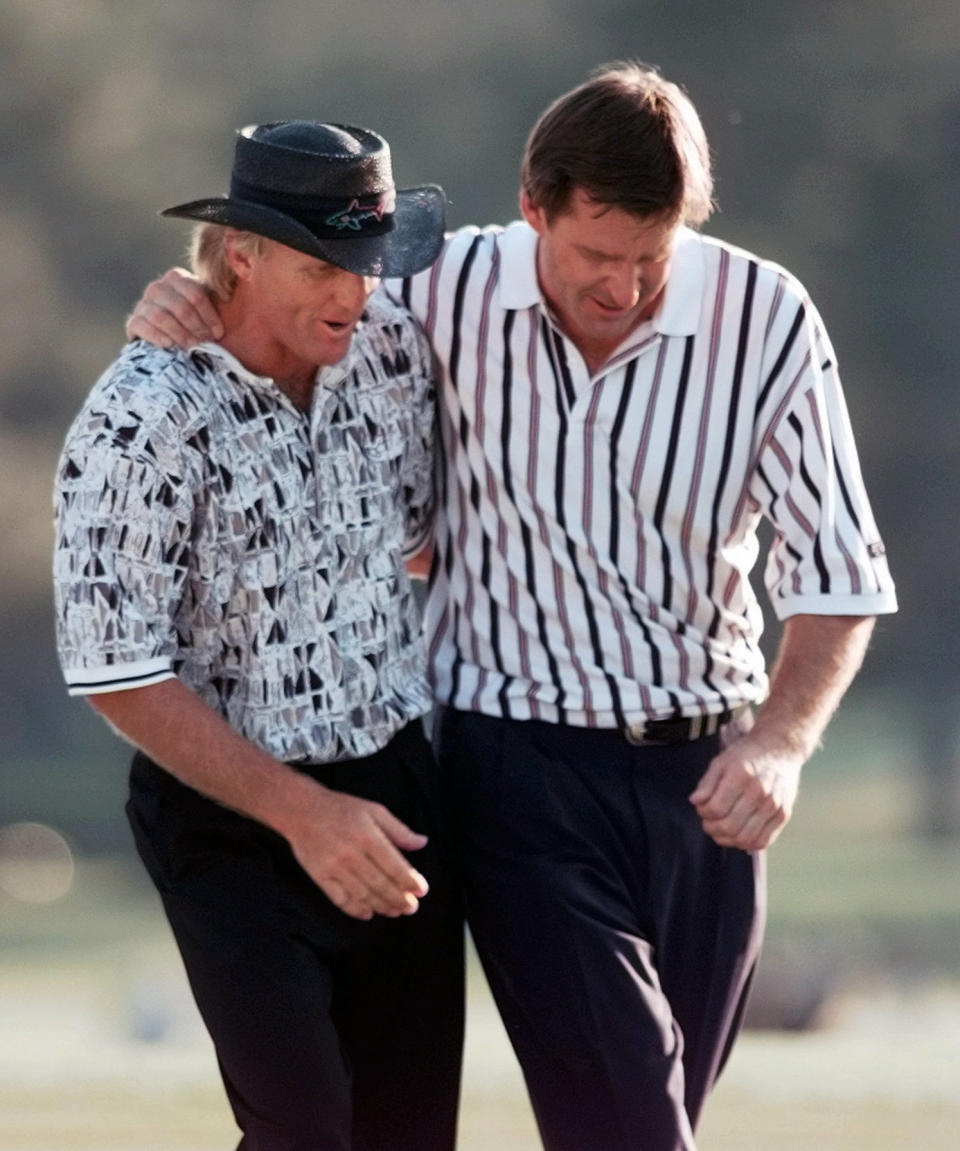 FILE - In this Sunday, April 14, 1996 file photo, England's Nick Faldo, right, and Australia's Greg Norman walk off the 18th after Faldo won his third Masters at the Augusta National Golf Club in Augusta, Ga. It was voted 5th-best Masters from a panel of golf writer (AP Photo/Dave Martin, File)