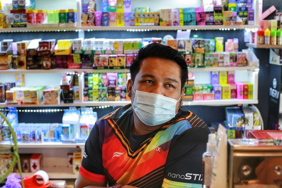 Lokman Hakim bin Mohd Yusof, 25, runs Puppetborn Vape in Kampung Baru worries that his customers will return to smoking cigarettes.