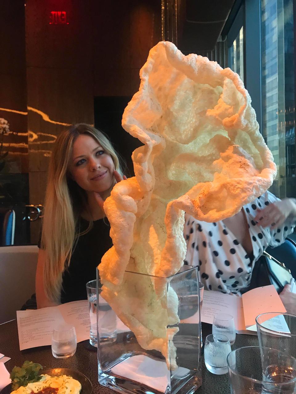 The giant piece of pork crackling at The Aviary in NYC is much bigger than one’s head. Photo: Yahoo Australia