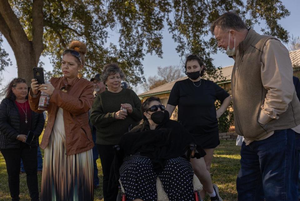 June Barker Green speaks with other loved ones after Donald Green's ashes have been spread into the Brazos River at a celebration of life in Freeport, on Dec. 16, 2023.