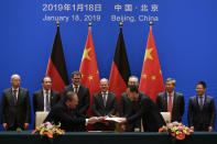 German Finance Minister Olaf Scholz, center, and Chinese Vice Premier Liu He, third right in the back, witness a signing ceremony after the China-Germany High Level Financial Dialogue at the Diaoyutai State Guesthouse in Beijing, Friday, Jan. 18, 2019. (AP Photo/Andy Wong, Pool)