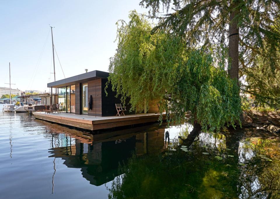 a five foot wide cedar deck extends the usable square footage of this float home on portage bay in seattle designed by studio diaa