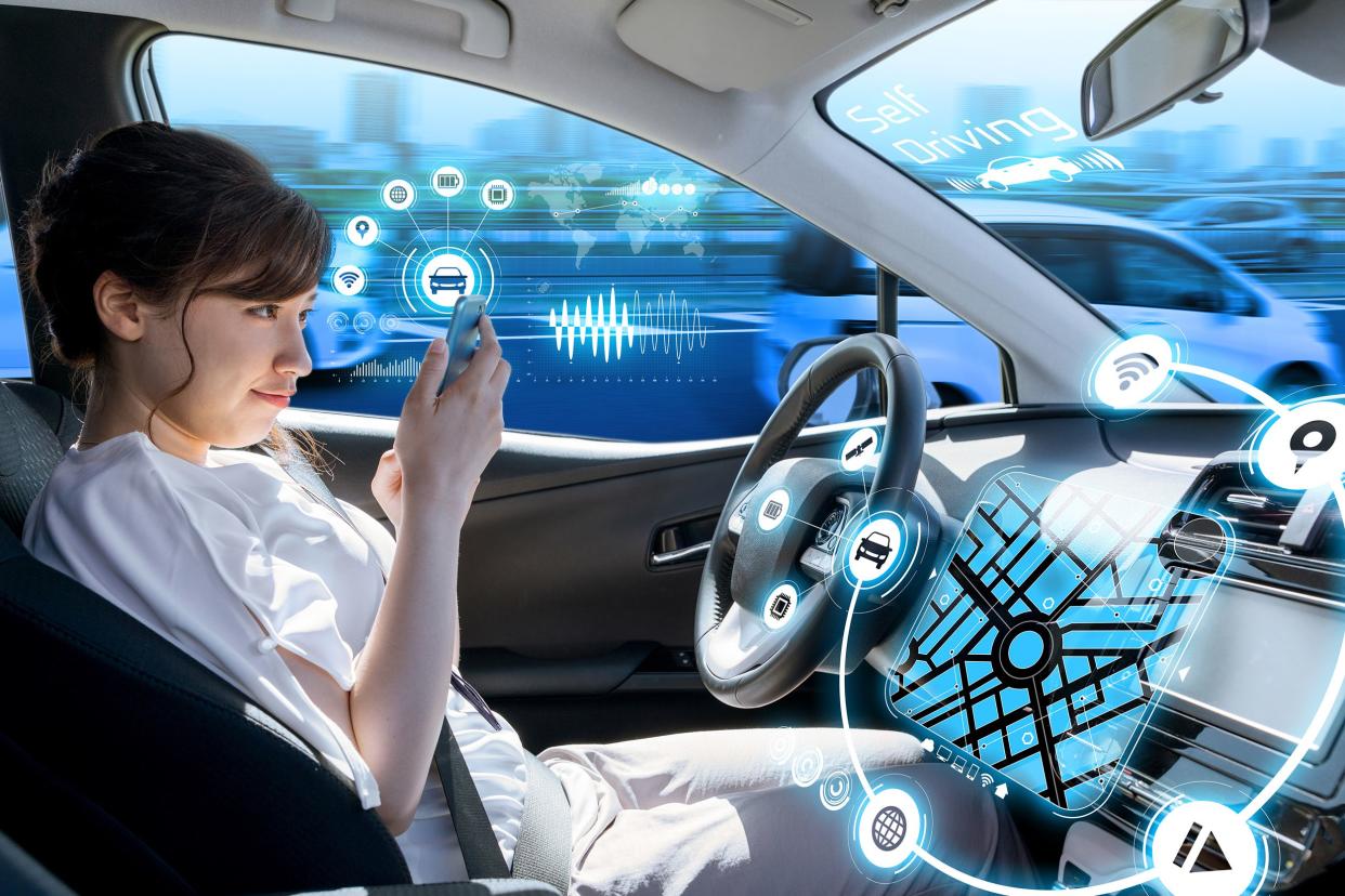 young woman using a smart phone in a autonomous car