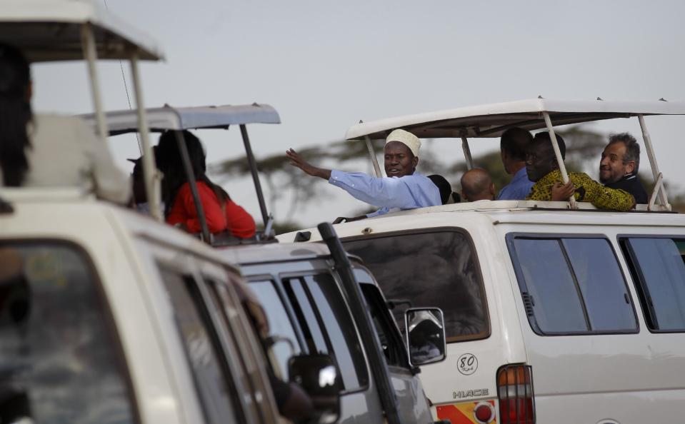 In this photo taken Thursday, Sept. 20, 2012, religious leaders of different faiths ride in safari buses to see the wildlife in Nairobi National Park, Kenya. Seeing a dire situation grow worse, the animal conservation group the World Wildlife Fund (WWF) enlisted religious leaders on Thursday, Sept. 20, 2012 in the fight to end the slaughter of Africa's elephants and rhinos by poachers, hoping that religion can help save some of the world's most majestic animals. (AP Photo/Ben Curtis)