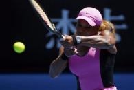 Serena Williams of the U.S. hits a return to Daniela Hantuchova of Slovakia during their women's singles matchat the Australian Open 2014 tennis tournament in Melbourne January 17, 2014. REUTERS/Petar Kujundzic