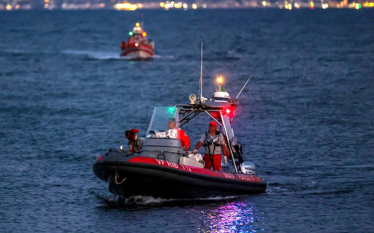 Italian fire brigade boats sail as a rescue operation continues