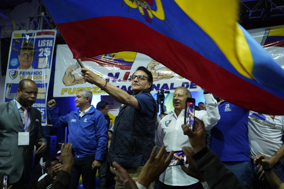 FILE - Presidential candidate Fernando Villavicencio waves a national flag during a campaign event at a school minutes before he was shot to death outside the same school, in Quito, Ecuador, Aug. 9, 2023. Villavicencio was fatally shot in broad daylight despite a security detail that included police and bodyguards. (API via AP File)