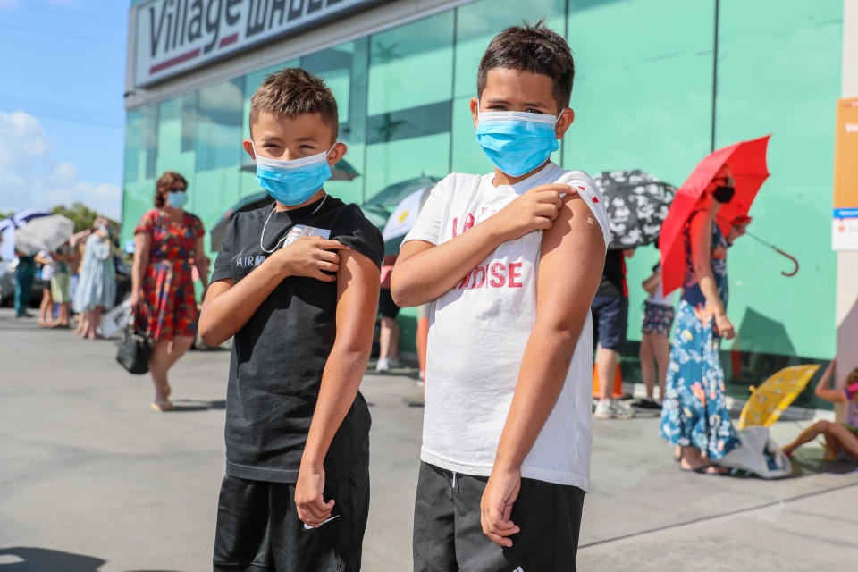 Brothers Louise and Harry Taylor-Bishop pose for a photo after receiving their first Covid vaccine at Kippa Ring Communication Vaccination Clinic, Brisbane, Monday. Source: AAP