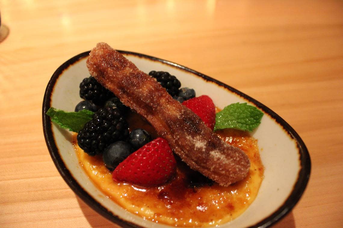 Creme Brulee de Calabaza, custard base layered with corn liqueur, seasonal berries, and a golden fried churro is the dessert apart of the Destination Oaxaca limited time menu at Toro Toro Fort Worth.