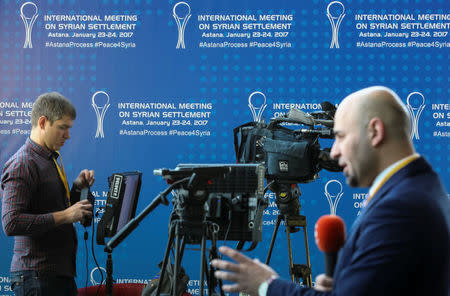 Reporters work in the media center set for Syria peace talks, in Astana, Kazakhstan, January 23, 2017. REUTERS/Mukhtar Kholdorbekov