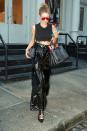 <p>In a black cropped top, high-waisted leather pants, lace-up pointed-toe shoes, crocodile leather handbag and Gentle Monster red oversized sunglasses in New York.</p>