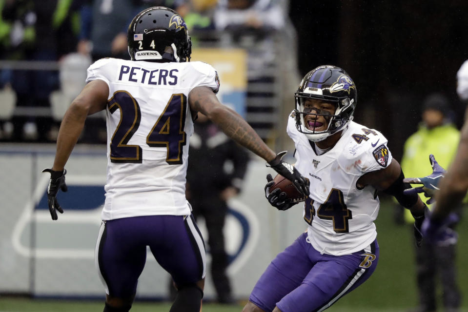 Baltimore Ravens cornerback Marlon Humphrey (44) celebrates with cornerback Marcus Peters (24) after recovering a Seattle Seahawks fumble and running for a touchdown during the second half of an NFL football game, Sunday, Oct. 20, 2019, in Seattle. (AP Photo/Elaine Thompson)