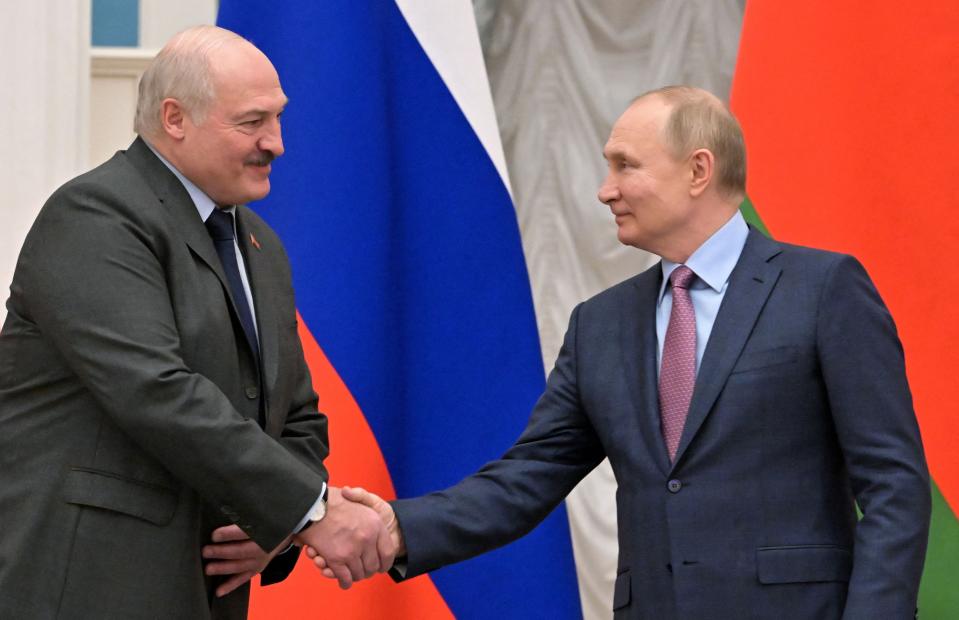 Russia's President Vladimir Putin (R) shakes hands with his Belarus counterpart Alexander Lukashenko (L) following their talks at in Moscow on February 18, 2022.