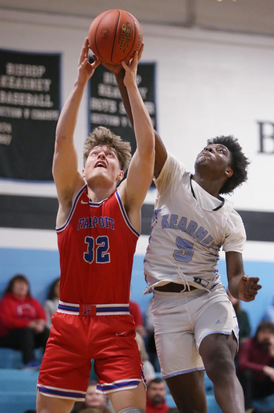 Fairport's Aidan White and Bishop Kearney's Jaden Capers battle for a rebound.