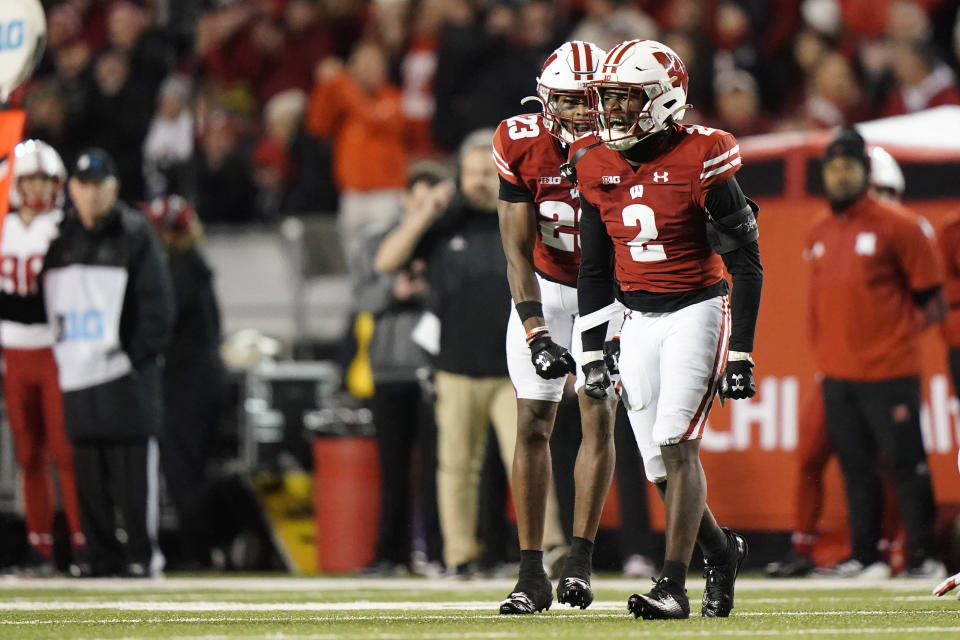 Wisconsin's Ricardo Hallman (2) reacts with Jason Maitre (23) during the second half of an NCAA college football game against Nebraska Saturday, Nov. 18, 2023 in Madison, Wis. (AP Photo/Aaron Gash)