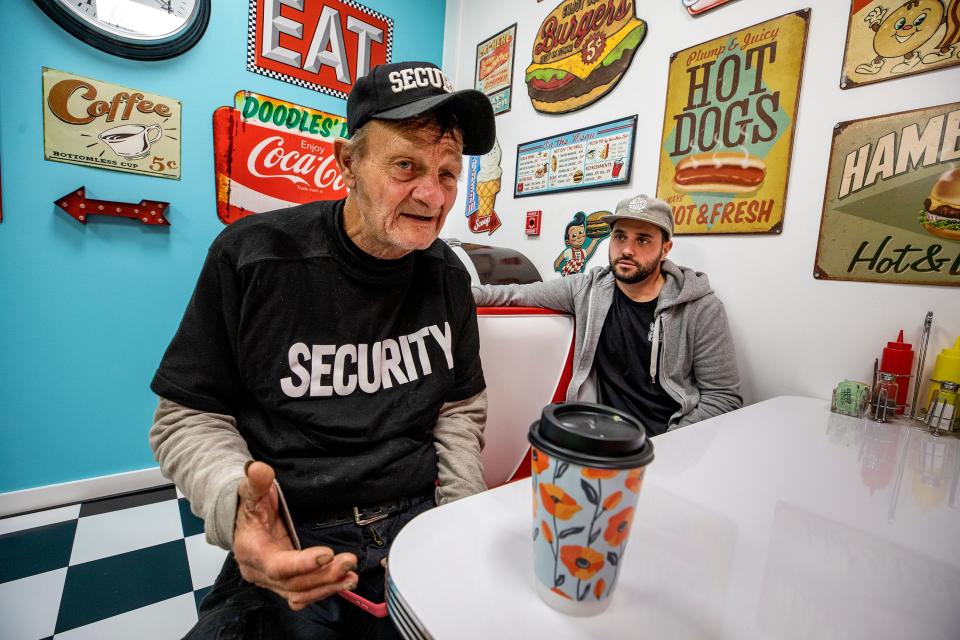 Lloyd Gainey, left, sits with Travis Settineri in the Lakeland headquarters of Worth and Purpose, a religious nonprofit formed by Settineri and his wife, Amber. Gainey has been homeless for 31 years before the couple found him a place to live and helped him establish side jobs detailing cars and doing lawn work.