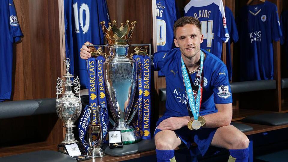 Andy King takes the League One, Championship and Premier League trophies