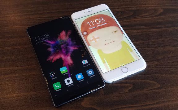 The Mi Mix next to an iPhone 7 Plus (right).