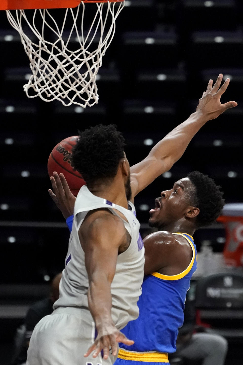 Pittsburgh guard Xavier Johnson, right, drives to the basket against Northwestern guard Anthony Gaines during the first half of an NCAA college basketball game in Evanston, Ill., Wednesday, Dec. 9, 2020. (AP Photo/Nam Y. Huh)