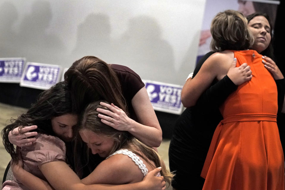 FILE - People hug during a "Value Them Both" watch party after a question involving a constitutional amendment removing abortion protections from the Kansas constitution failed, Aug. 2, 2022, in Overland Park, Kan. Kansas legislators have given final approval to a bill that could subject doctors to lawsuits or criminal charges if they're accused of not providing enough care to infants born during abortion procedures. The Kansas House voted 86-36 on Tuesday, April 4, 2023, to approve a “born-alive infants protection” measure similar to a proposed law rejected by Montana voters in November. (AP Photo/Charlie Riedel, File)