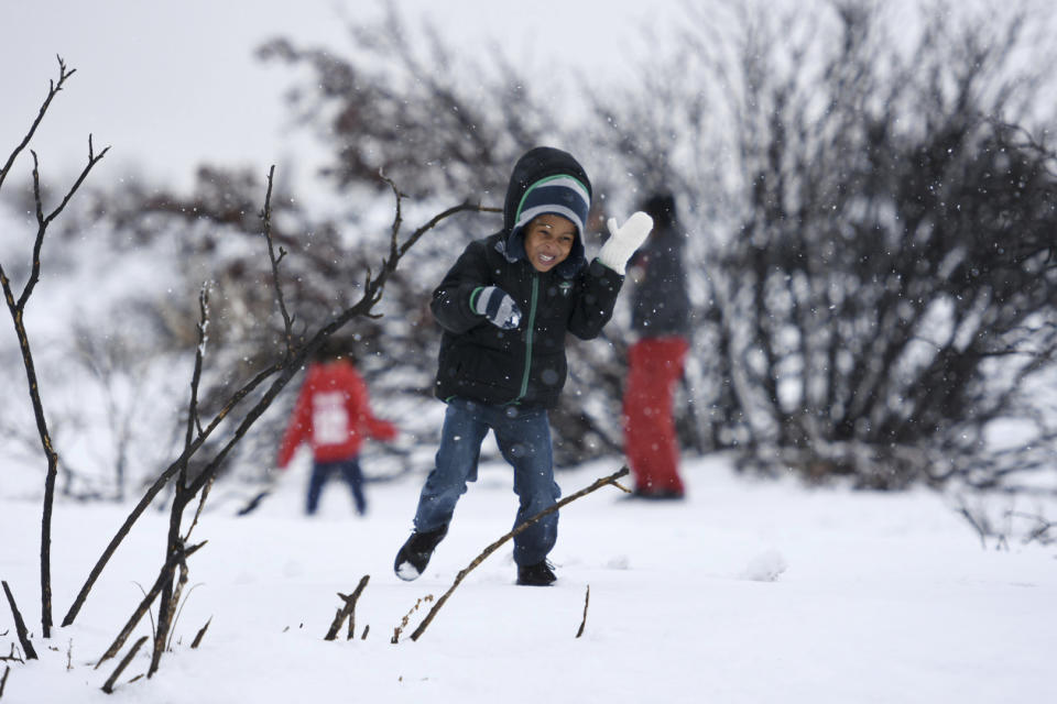 Amare Dunn, 4, of Victorville, Calif., dodges a snowball while playing with his family in Oak Hills, Calif., on Monday, Jan., 23, 2017. (David Pardo/The Daily Press via AP)