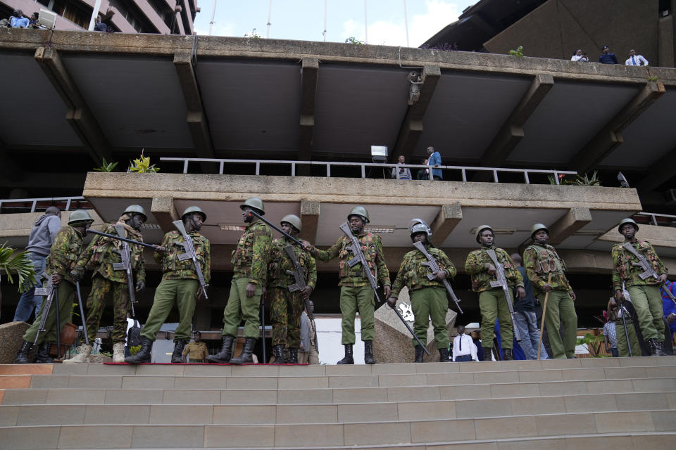 Soldiers stand outside the campaign headquarters of Kenyan presidential candidate Raila Odinga in downtown Nairobi, Kenya, Tuesday, Aug. 16, 2022. Kenya is calm a day after Deputy President William Ruto was declared the winner of the narrow presidential election over longtime opposition figure Raila Odinga. (AP Photo/Mosa'ab Elshamy)