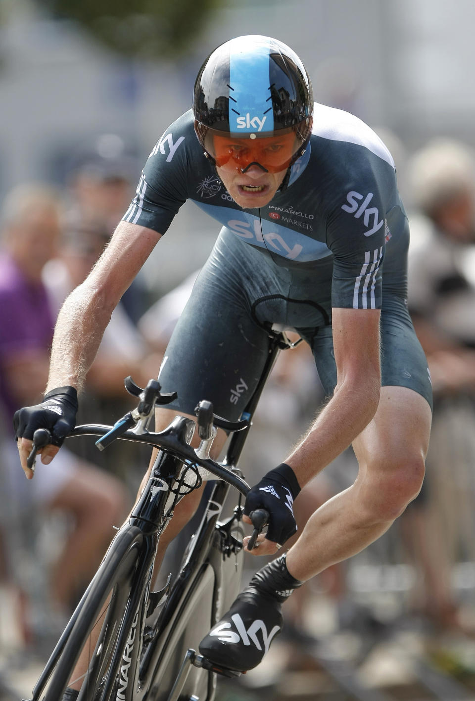 FILE - In this Thursday, June 7, 2012 file photo, Sky's Christopher Froome of Great Britain, negotiates a curve during the fourth stage of the 64th Dauphine cycling race, a 53,6 kilometers individual time trial between Villie-Morgon and Bourg-en-Bresse, central France. Four-time Tour de France winner Chris Froome will miss this year’s race after a “bad crash” in training on Wednesday June 12, 2019. Team INEOS leader Dave Brailsford said Froome sustained a suspected fractured femur in a 60 kph (40 mph) crash. (AP Photo/Claude Paris, File)