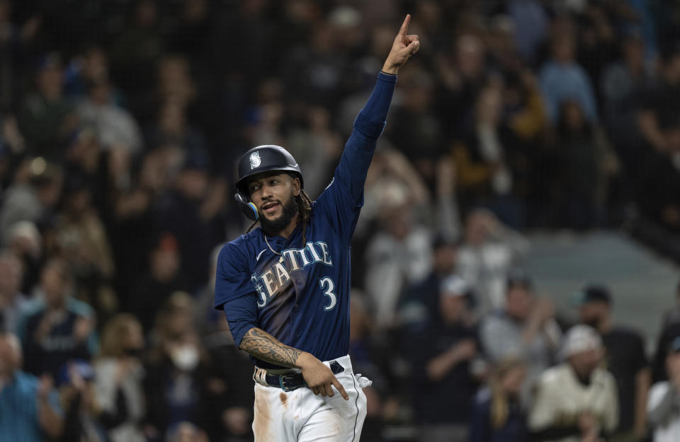 Seattle Mariners' J.P. Crawford celebrates after scoring a run on a double by Jessie Winker off Baltimore Orioles relief pitcher Felix Bautista during the eighth inning of a baseball game Tuesday, June 28, 2022, in Seattle. (AP Photo/Stephen Brashear)