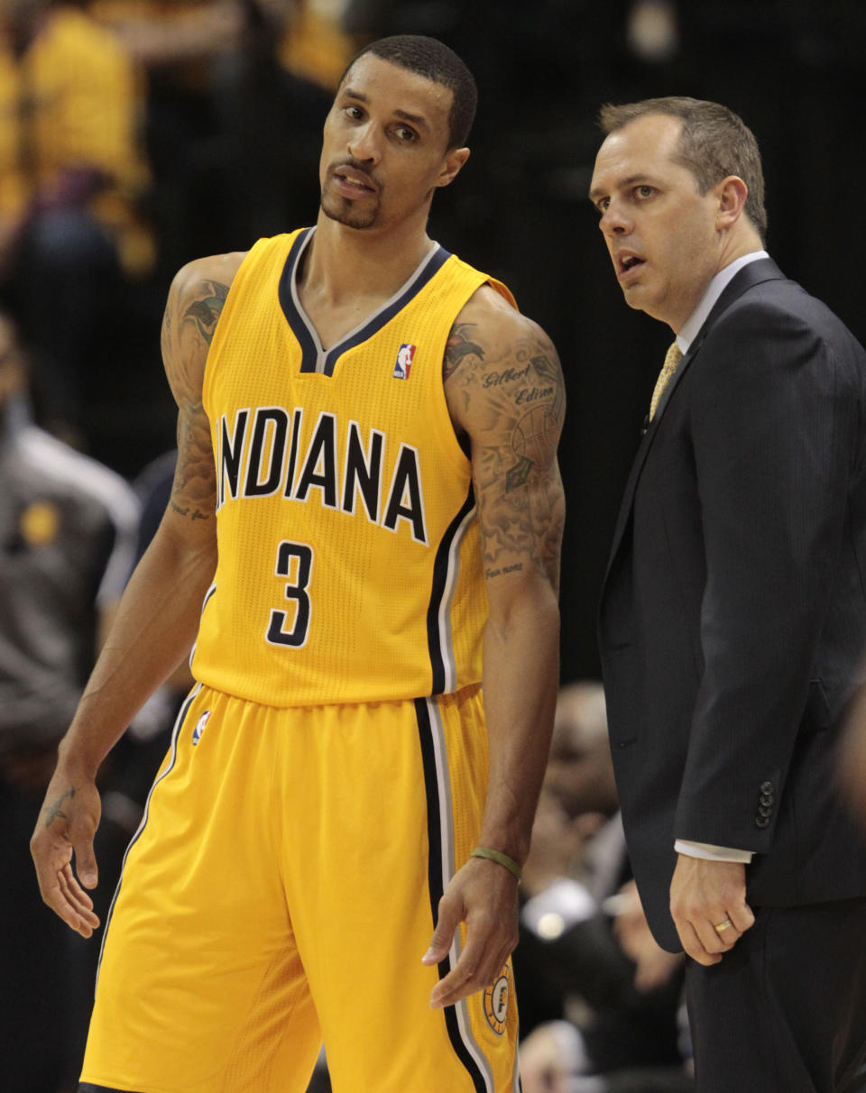 Indiana Pacers head coach Frank Vogel, right, talks with George Hill (3) in the second half during Game 7 of a first-round NBA basketball playoff series against the Atlanta Hawks in Indianapolis, Saturday, May 3, 2014. The Pacers won 92-80. (AP Photo/AJ Mast)