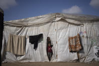 A Palestinian girl, displaced by the Israeli ground offensive on the Gaza Strip is seen at the makeshift tent camp in Rafah on Tuesday, Jan. 23, 2024. (AP Photo/Fatima Shbair)