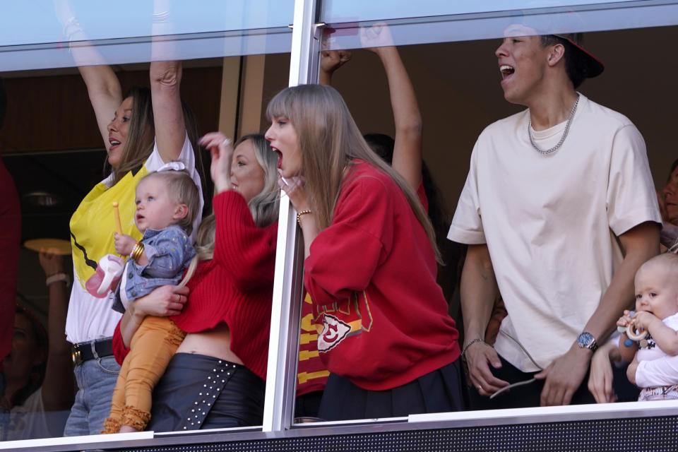 Taylor Swift celebrates as she watches from a suit during the first half of an NFL football game between the Kansas City Chiefs and the Los Angeles Chargers Sunday, Oct. 22, 2023, in Kansas City, Mo. (AP Photo/Ed Zurga)