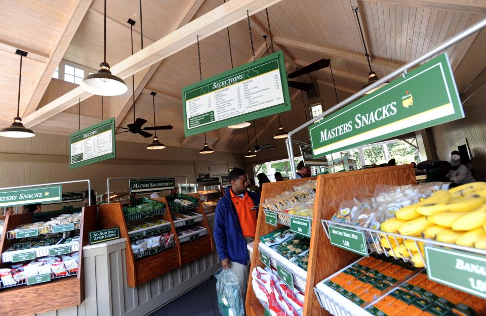 Patrons buy food and drinks at a concessions area at the Masters Tournament at Augusta National Golf Club.