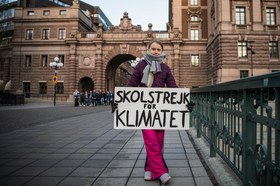 TOPSHOT - 17-years-old Swedish climate activist Greta Thunberg holds a poster reading "School strike for Climate" as she protests in front of the Swedish Parliament, where she goes on school strike on January 10, 2020 in Stockholm. (Photo by Jonathan NACKSTRAND / AFP) (Photo by JONATHAN NACKSTRAND/AFP via Getty Images)