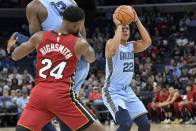 Memphis Grizzlies guard Desmond Bane (22) shoots as forward Jaren Jackson Jr. and Miami Heat forward Haywood Highsmith (24) move for position in the first half of an NBA basketball game, Wednesday, Nov. 8, 2023, in Memphis, Tenn. (AP Photo/Brandon Dill)