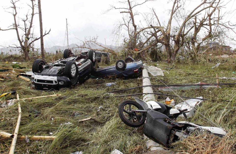 Overturned vehicles are seen at a rice field after super Typhoon Haiyan battered Tacloban city