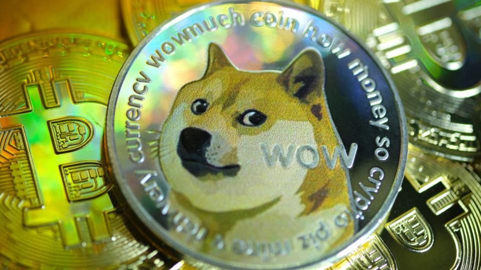 In this photo illustration, visual representations of digital cryptocurrencies, Dogecoin and Bitcoin are arranged.